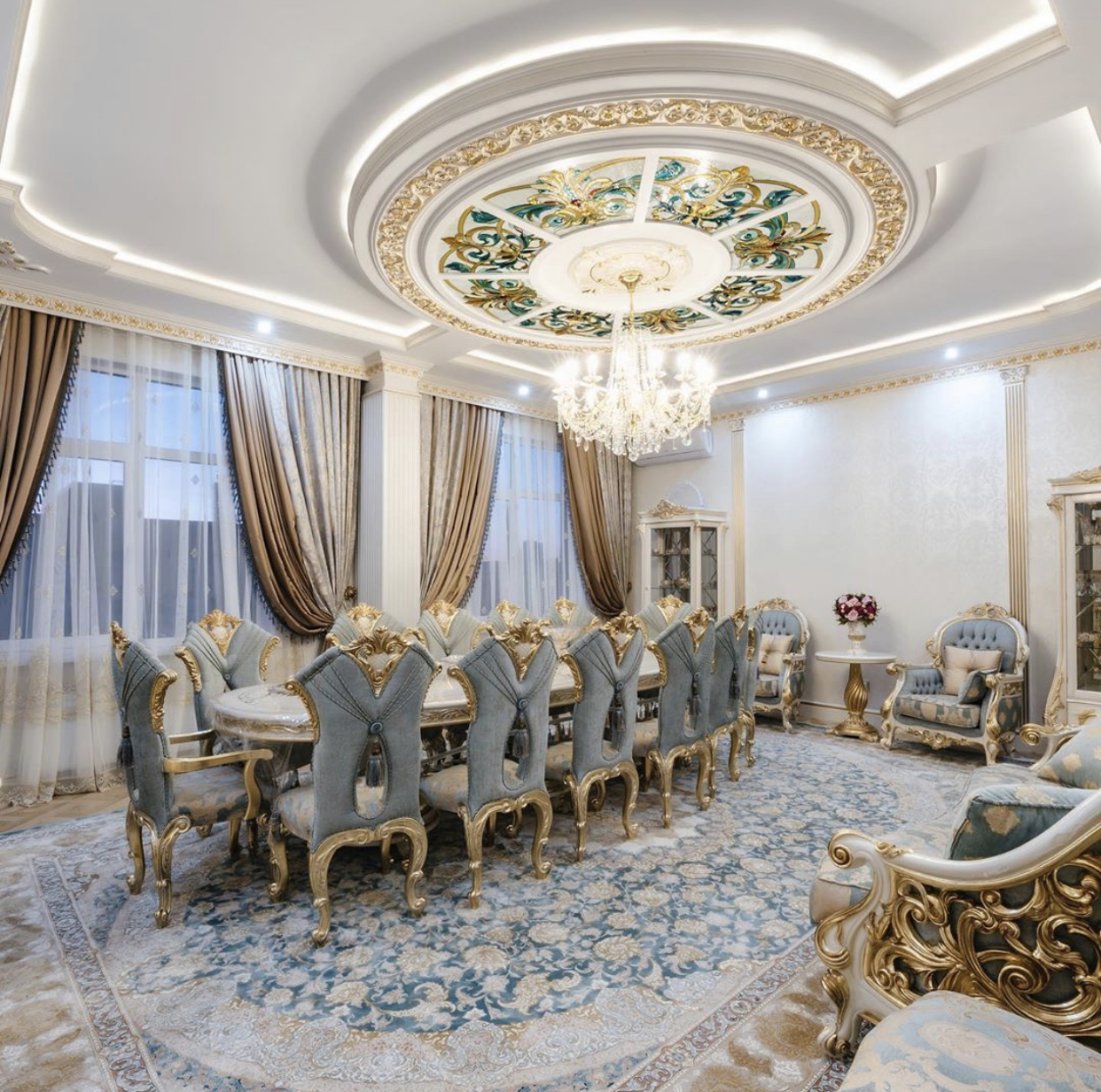 Luxury dining room with circular stained-glass ceiling laylight, crystal chandelier and ornate classic furniture