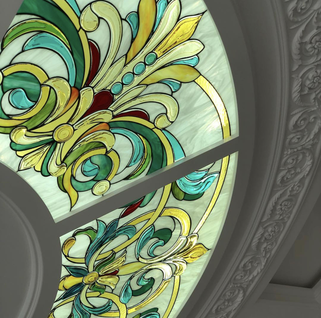 Close-up of stained glass ceiling panel with Art-Nouveau scrolls in emerald, teal, amber and gilded outlines